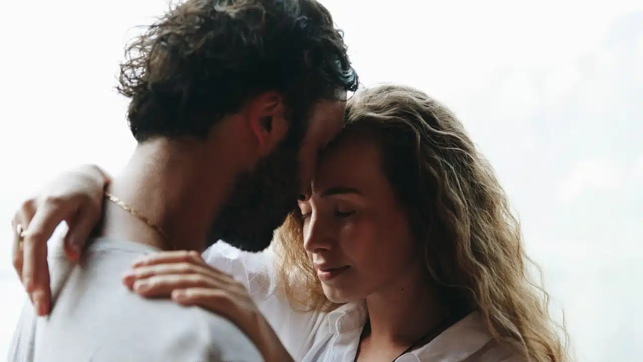 A couple with closed eyes touching foreheads and having a tender moment.