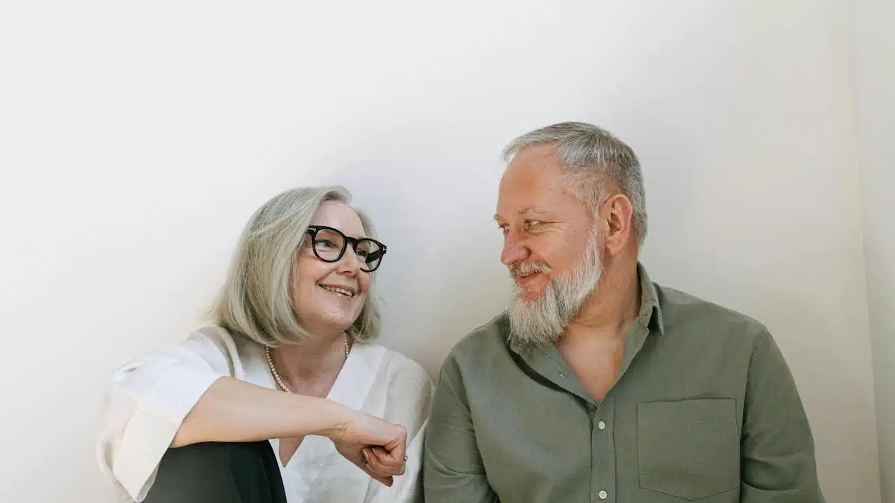 An older woman looking at each other and smiling.