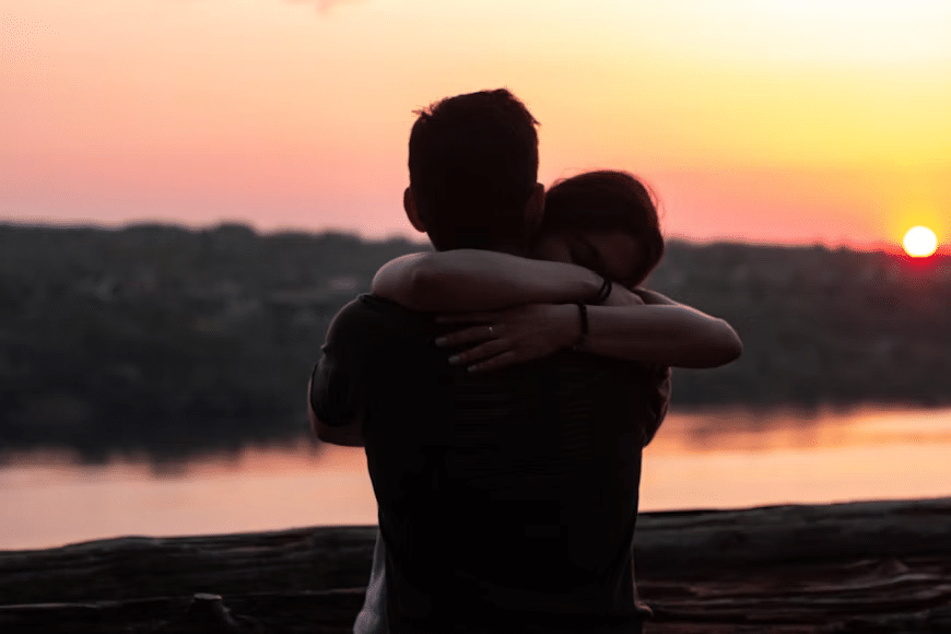 A man and women hugging each other emotionally after a patch up.