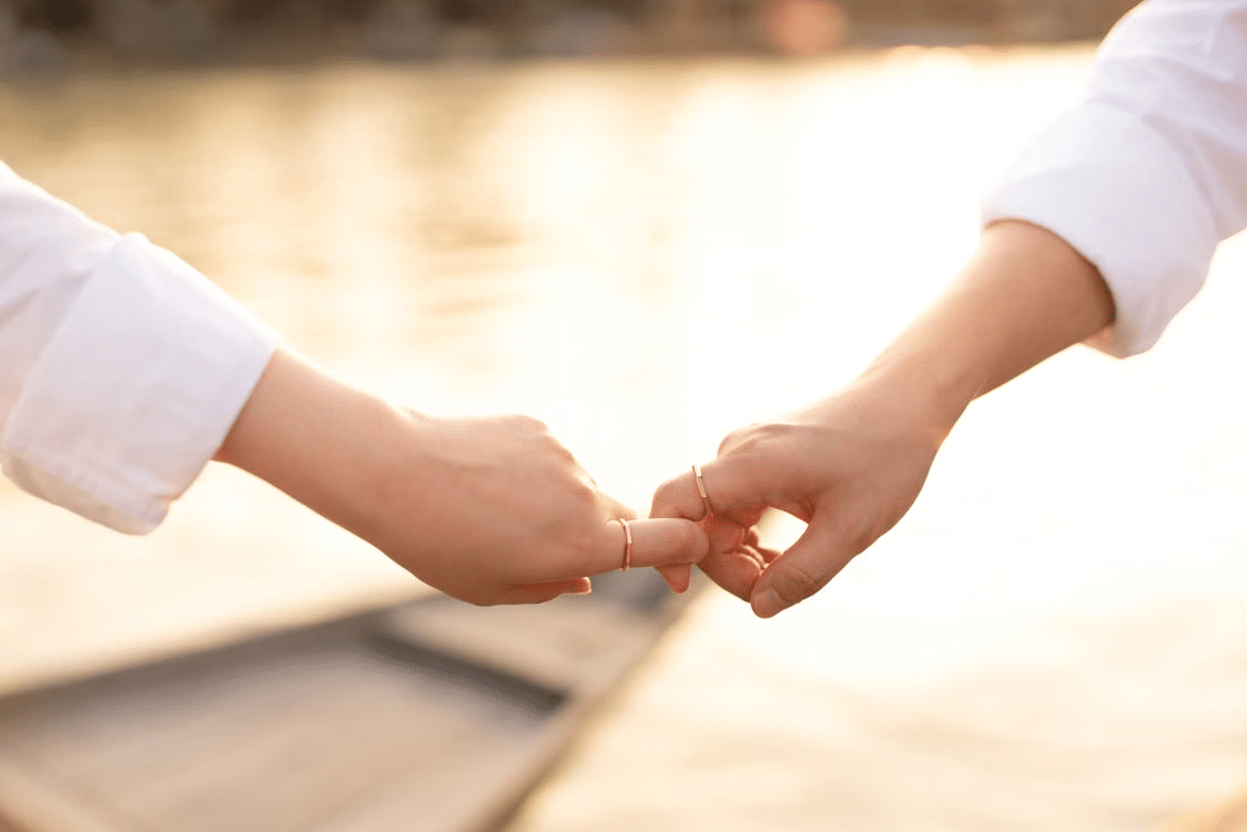 Couple making a pinky promise.