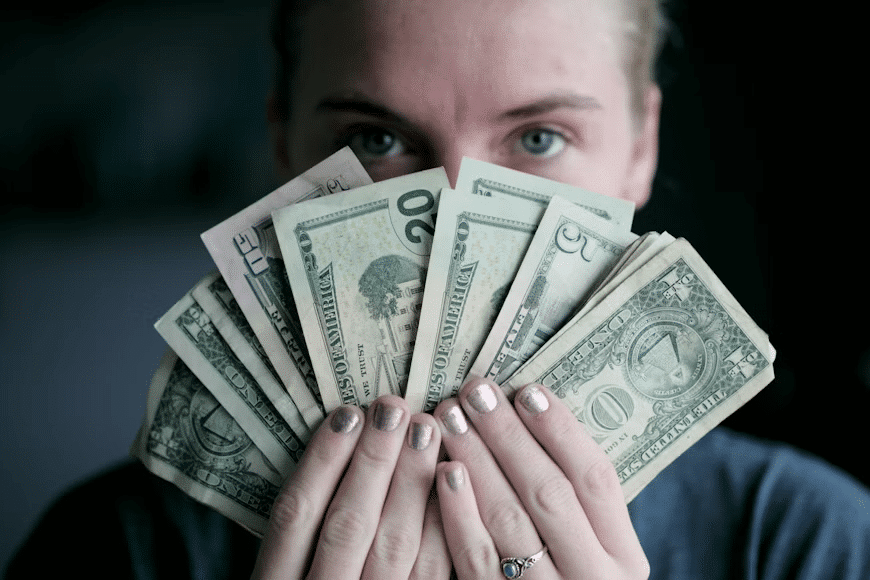 A woman holding money symbolizing how money holds power.