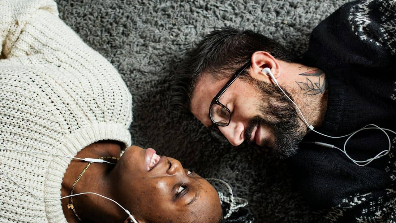 A couple listening to music together.