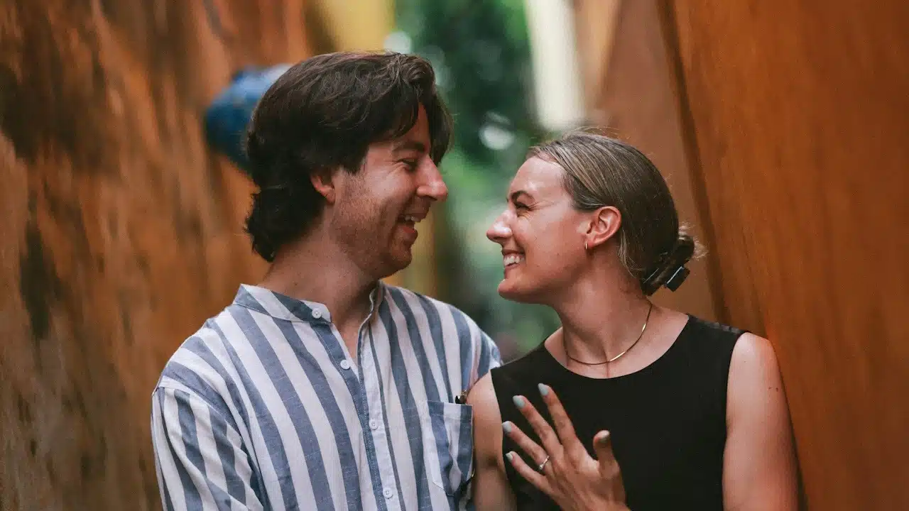 A couple smiling at each other.