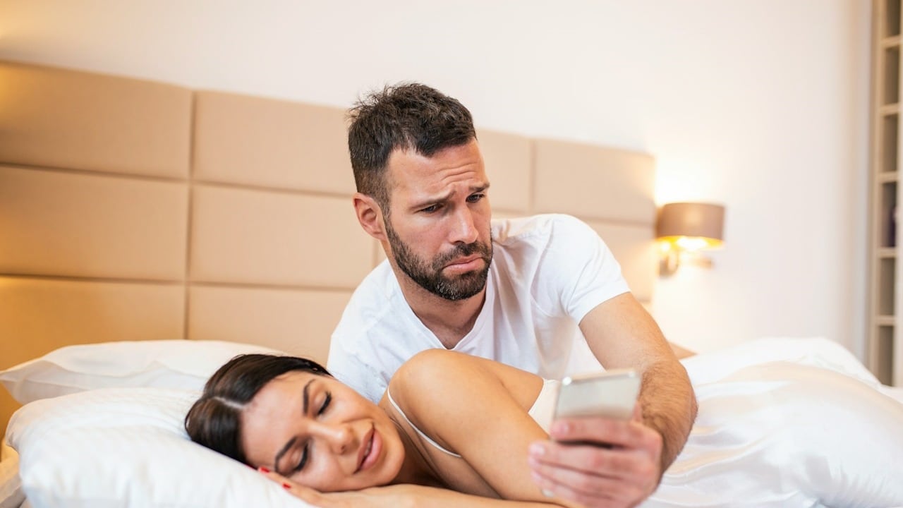Jealous husband spying on his wife's phone.