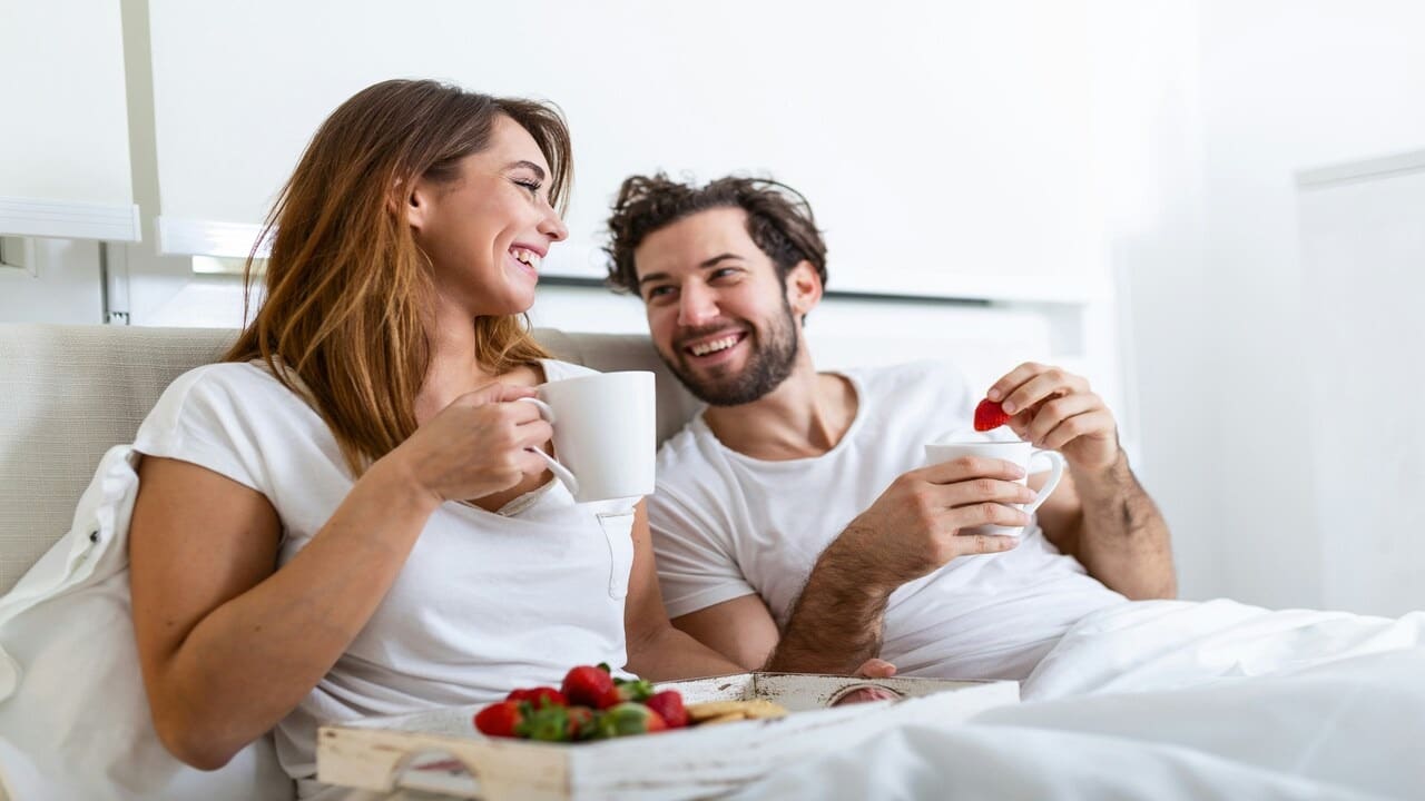 A couple having breakfast in bed