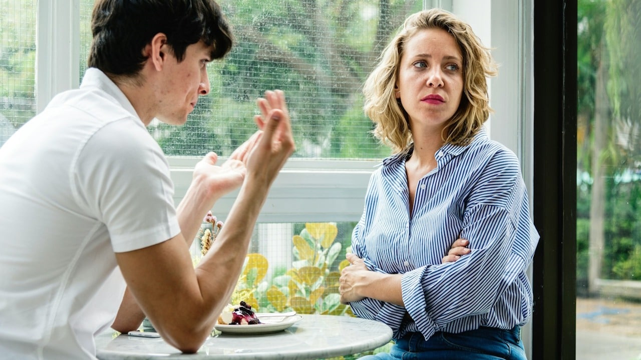 A couple having argument at the cafe.