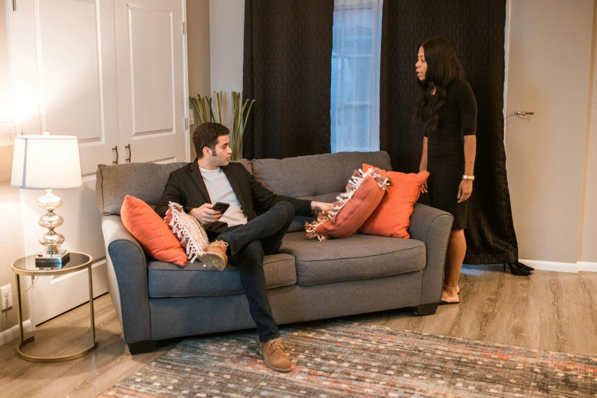 A man busy with his phone and a woman calling him