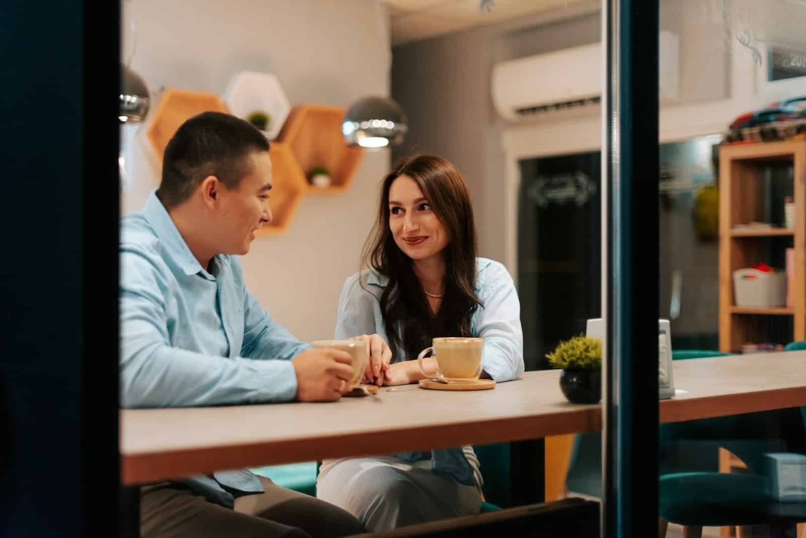 A couple talking in a café.