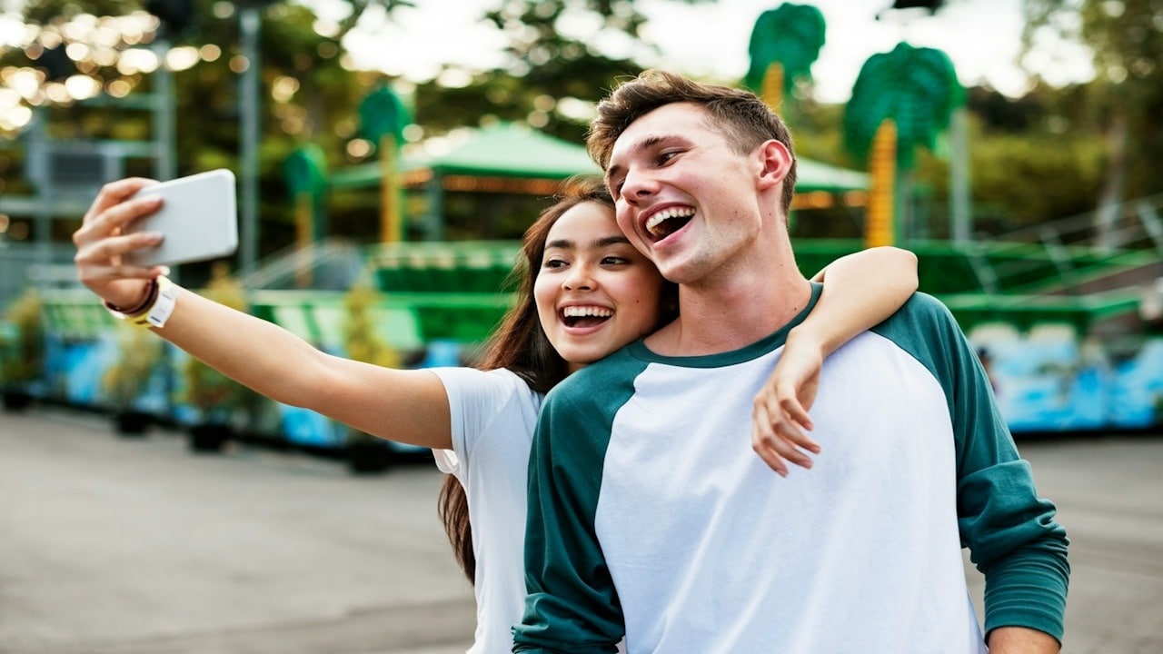 Young couple having fun together at an amusement park.