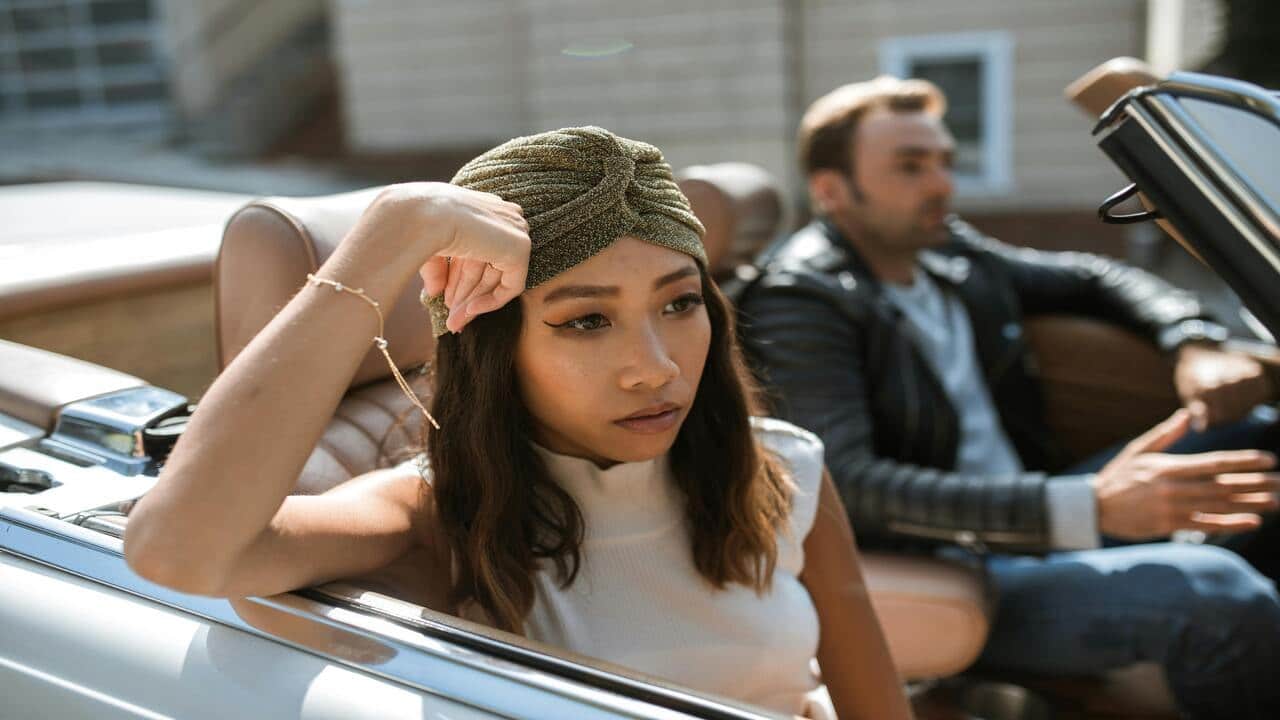 A woman ignoring her husband in the car