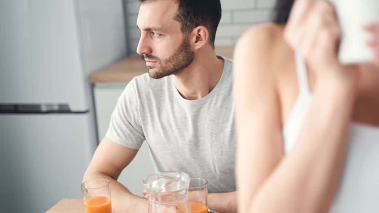 A couple avoiding eye contact during a conversation