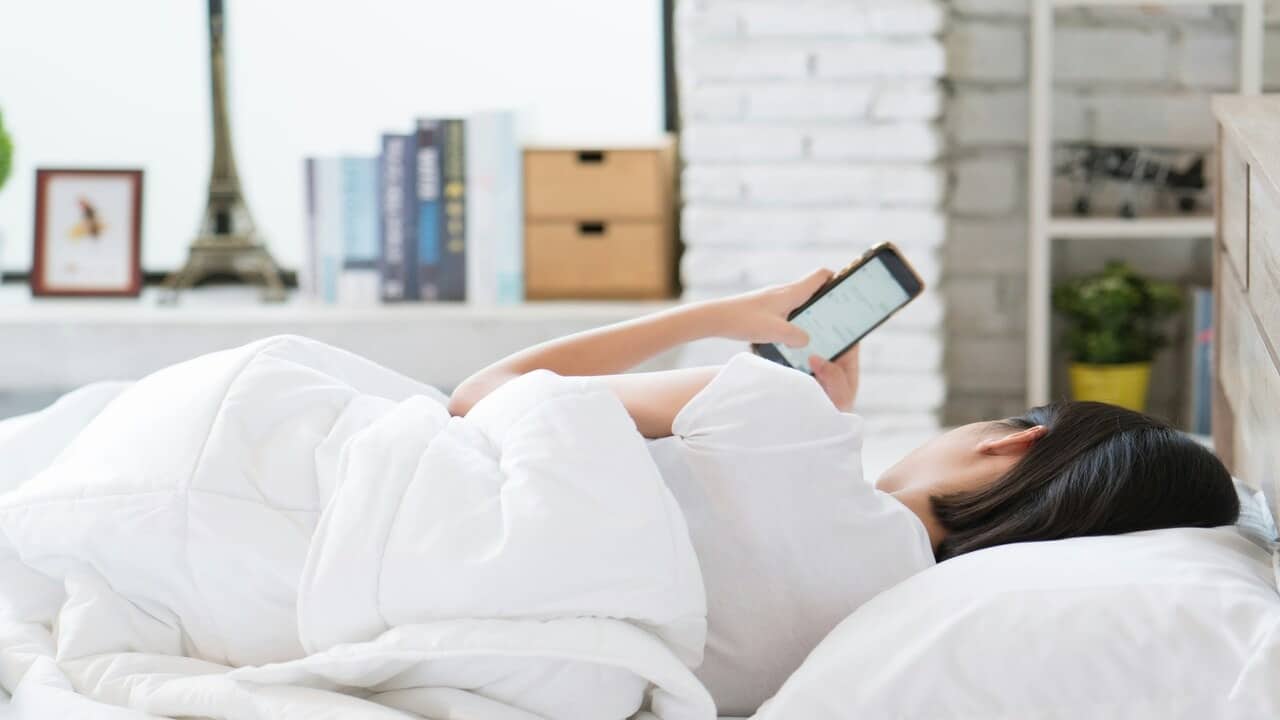A woman waiting for a text