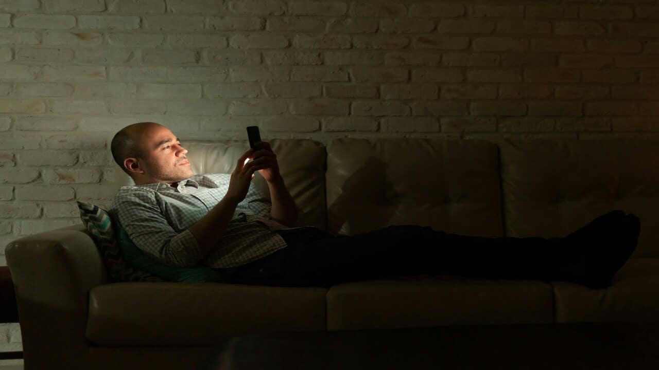 A man texting in the dark