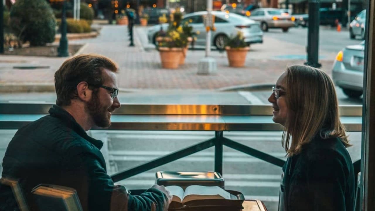 Couple sitting face to face, man listening attentively
