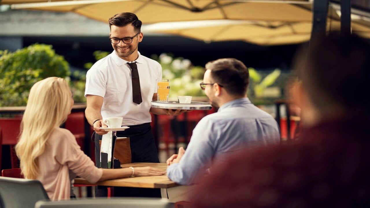 A couple talking to a waiter