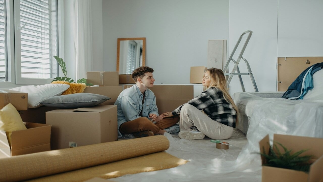 A couple talking amongst moving boxes