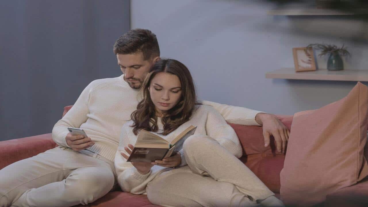 A couple reading at home together