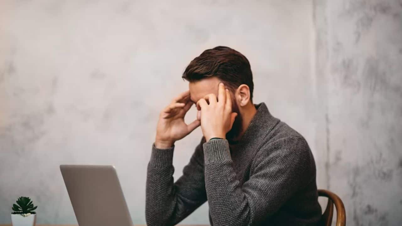 Man looking down quietly after a difficult conversation