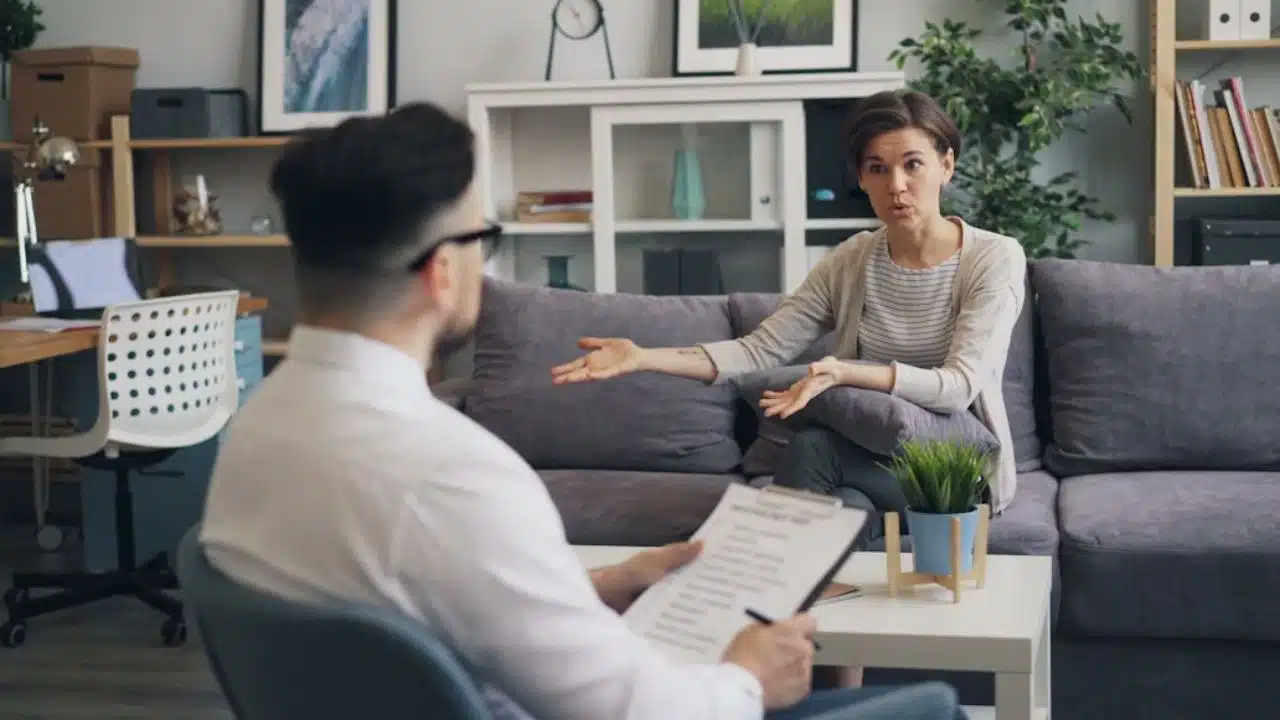 Man staying quiet while partner argues in living room