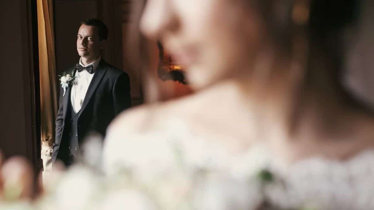 Woman looking thoughtful while observing a man across the room