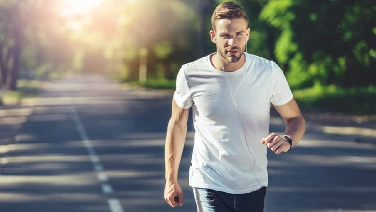 Man jogging at sunrise with determination