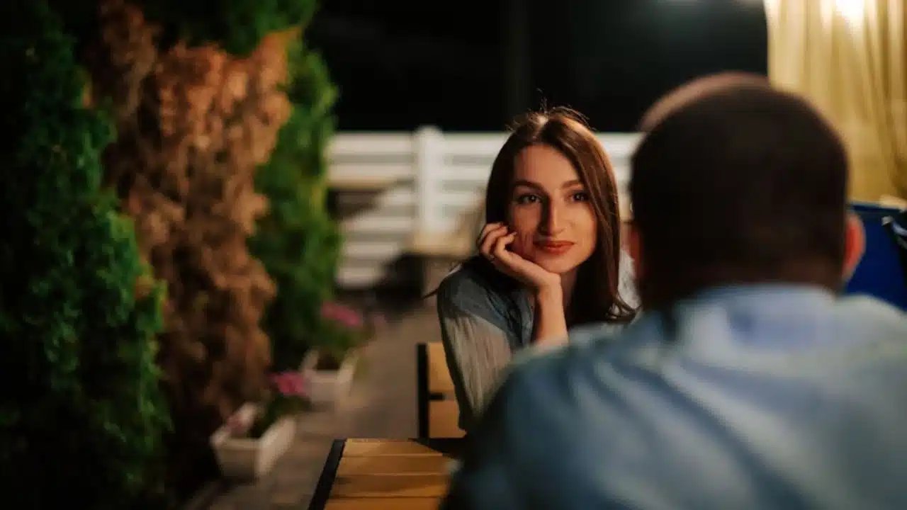 Woman quietly watching her partner while he looks distracted