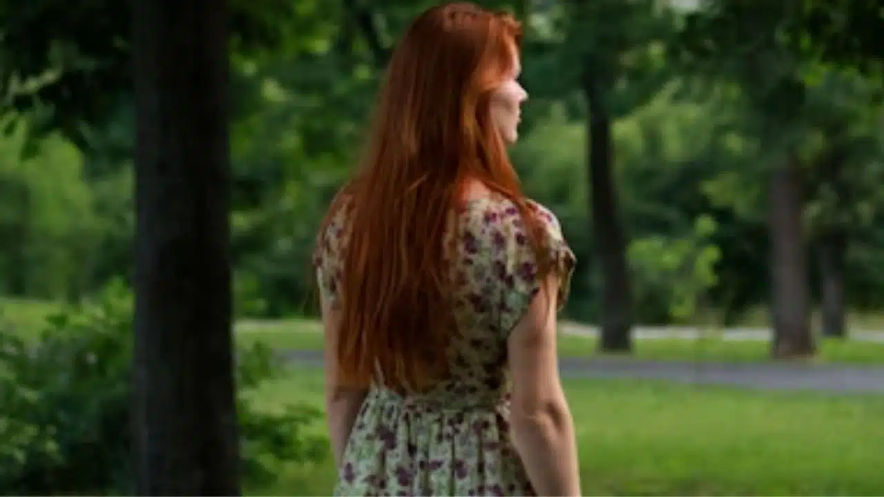 Woman walking alone outdoors, deep in thought