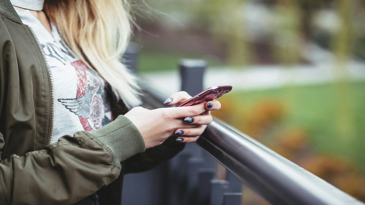 A woman texting outdoors