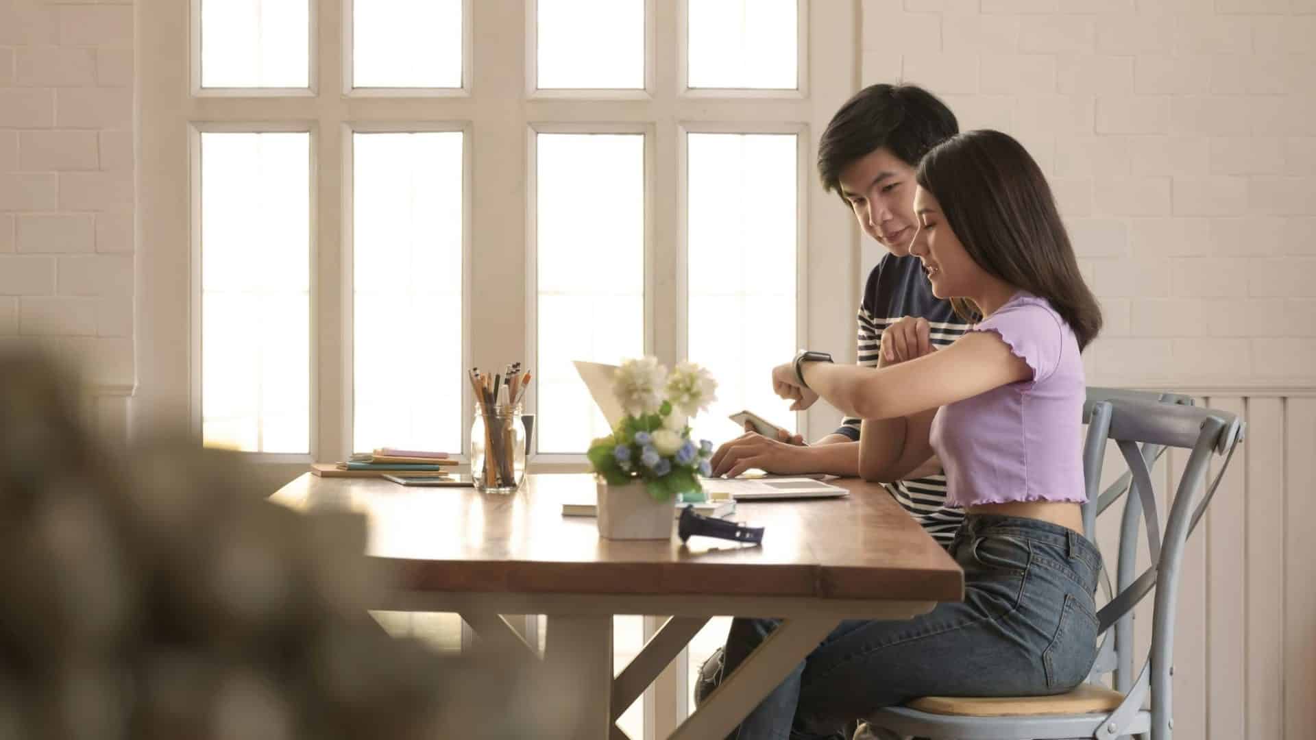 A man and woman looking at something