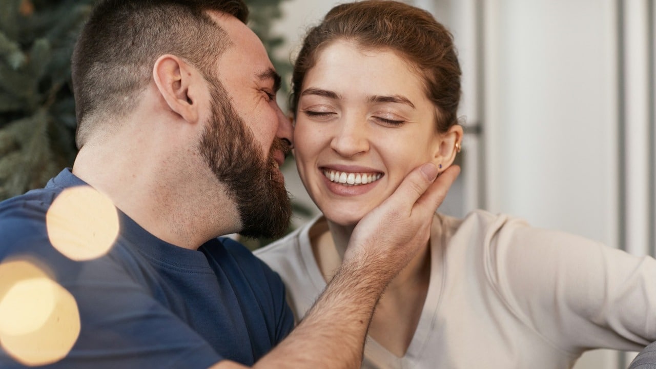 Happy man and woman looking in each other's eyes and smiling.