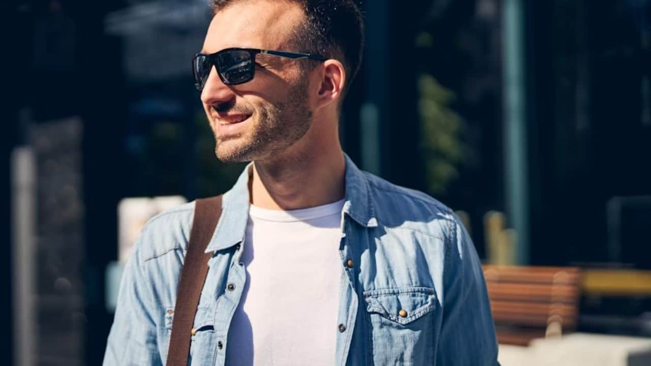 Man smiling confidently while walking outdoors