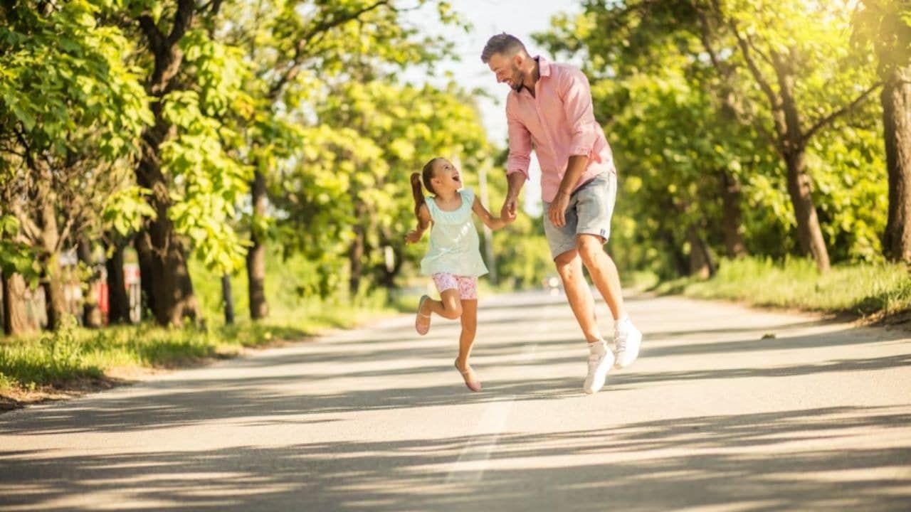 Man playing with his child in a park