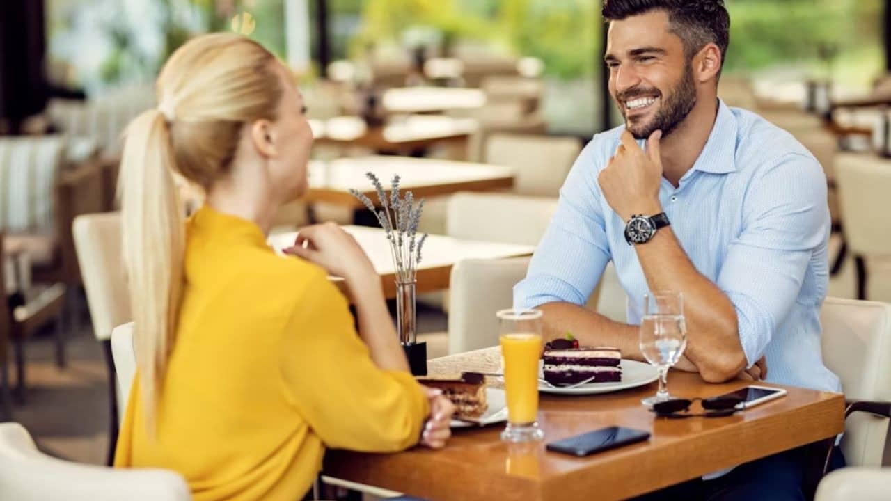 Man on a date, listening attentively with a relaxed smile.