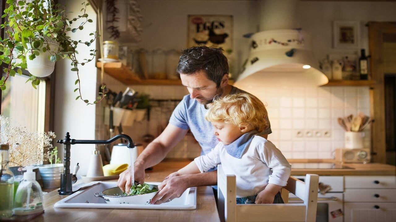 A man watching vegetables with his son