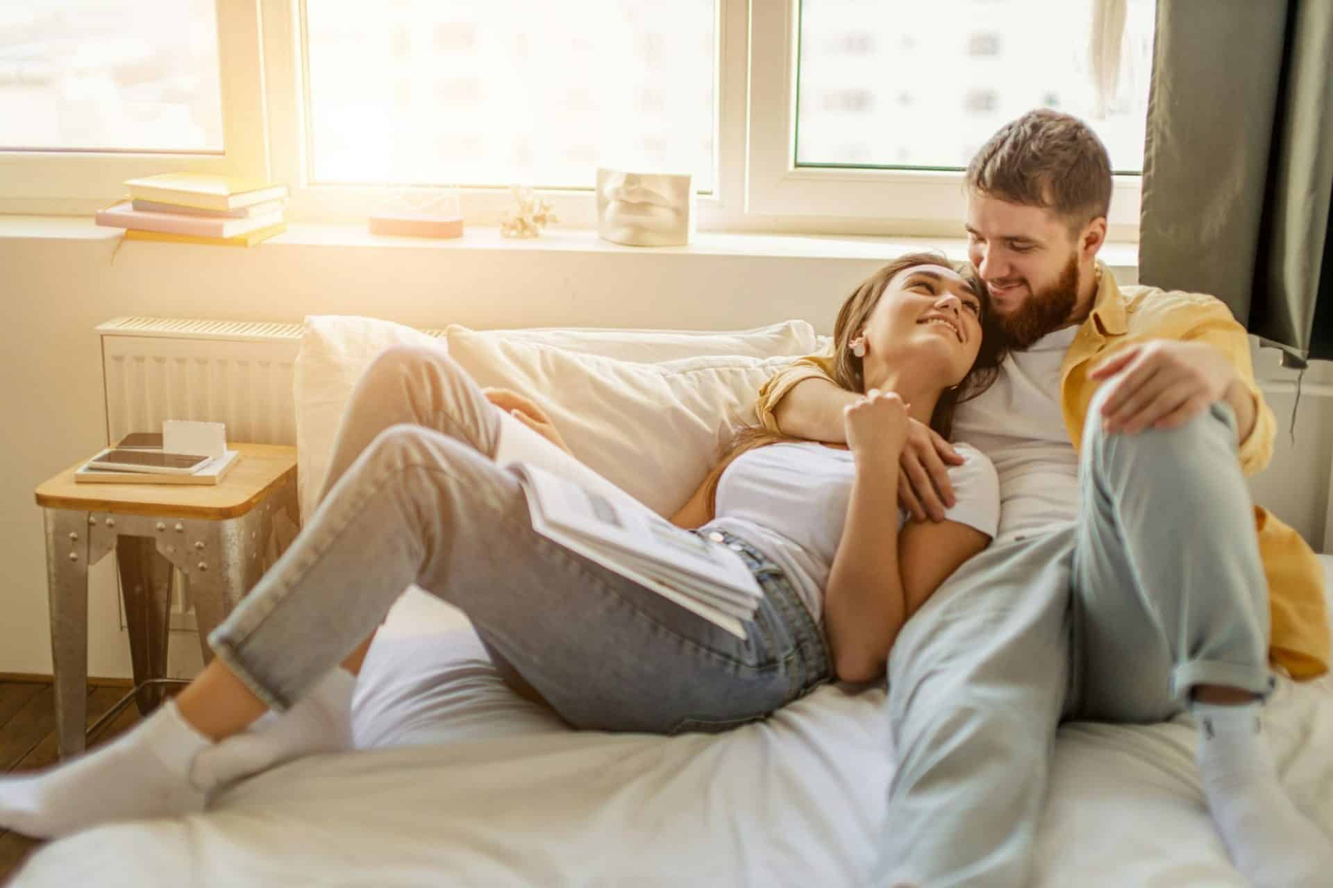 A man and woman at the bed