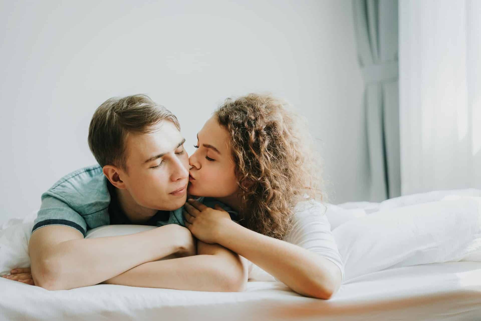 A woman kissing a man’s cheek