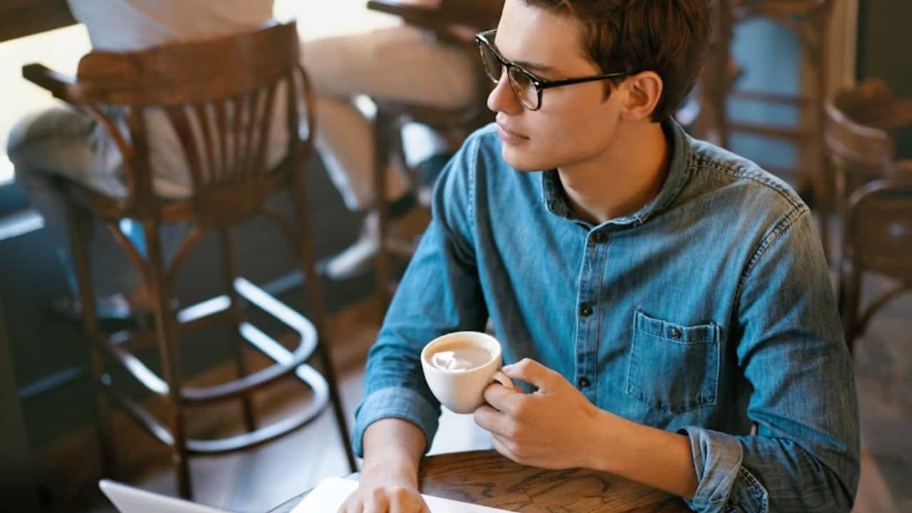 Man sitting calmly in a café during a stressful moment