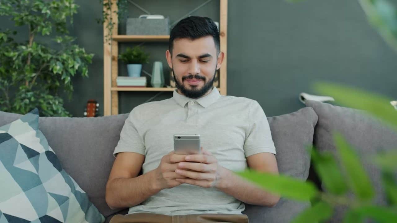 Man texting his partner regularly with genuine interest