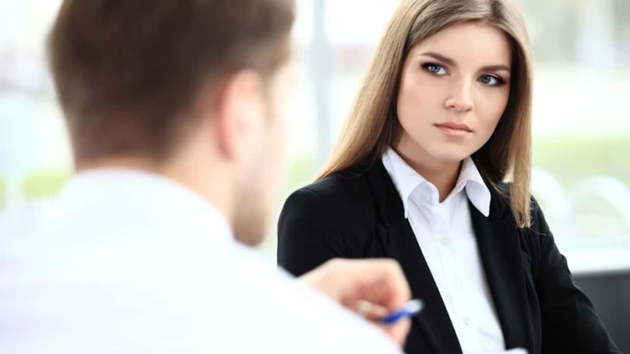 Woman observing her partner during a conversation, looking thoughtful