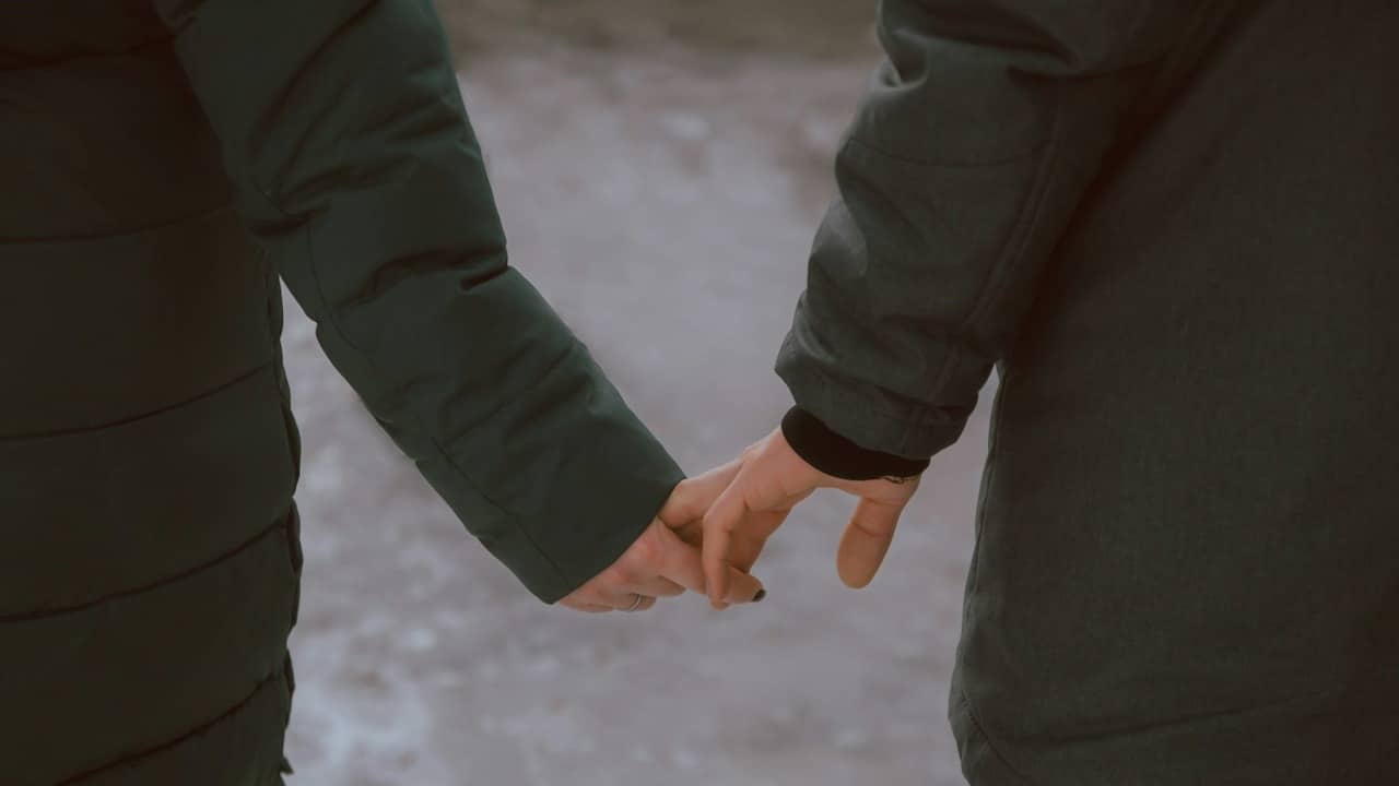 A couple holding hands.