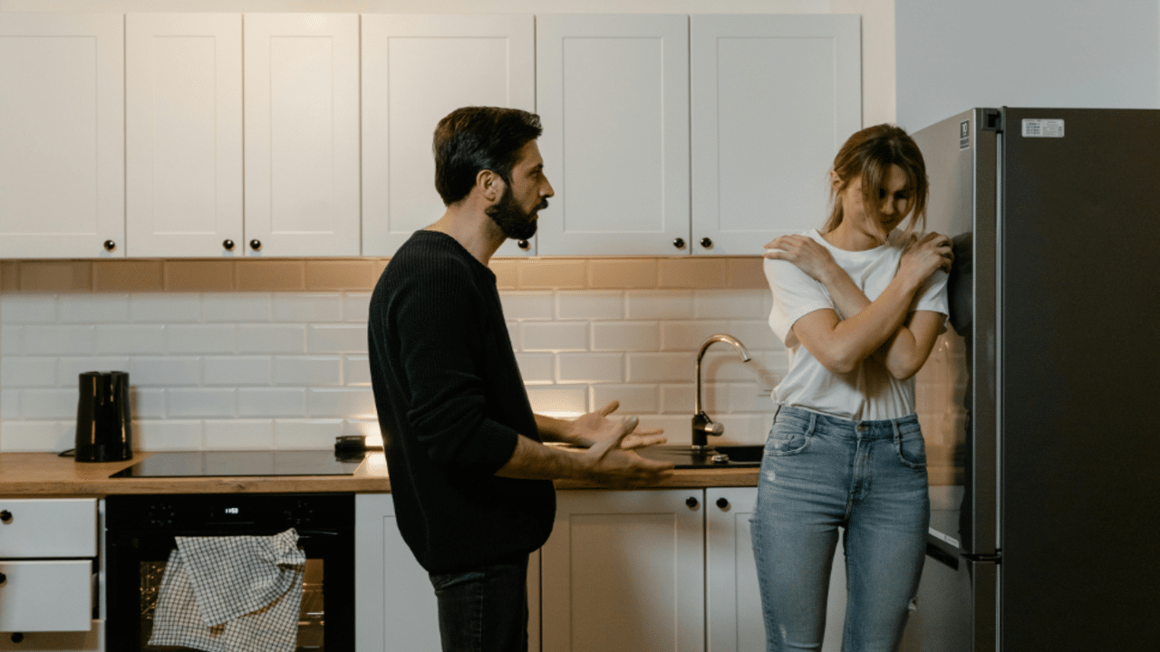 A couple having an argument in the kitchen