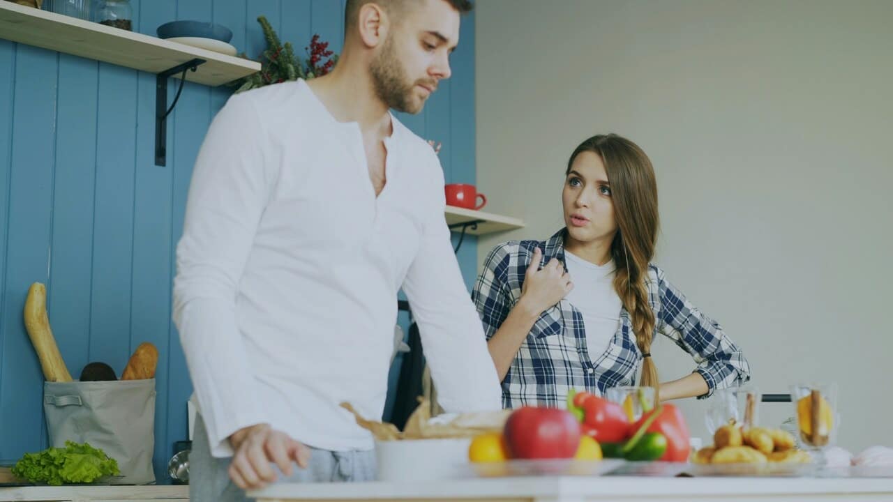 A couple having a serious talk in the kitchen