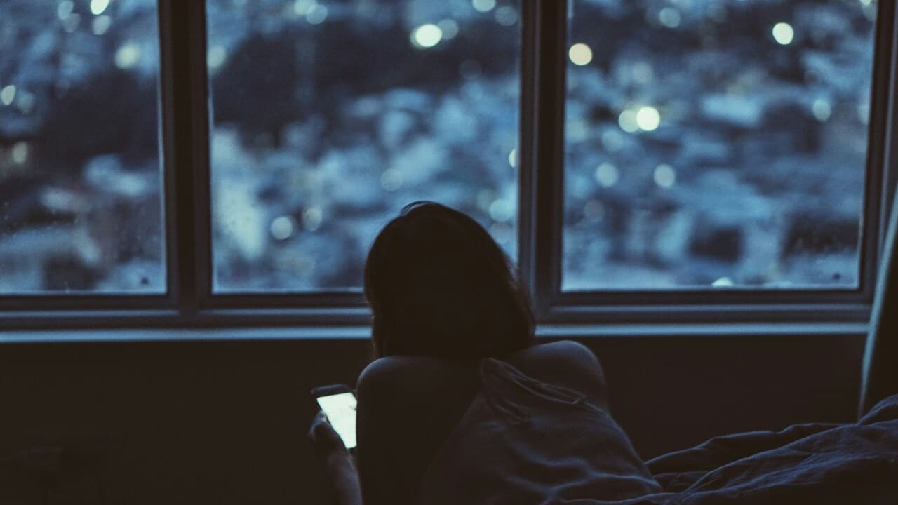 A woman texting late at night