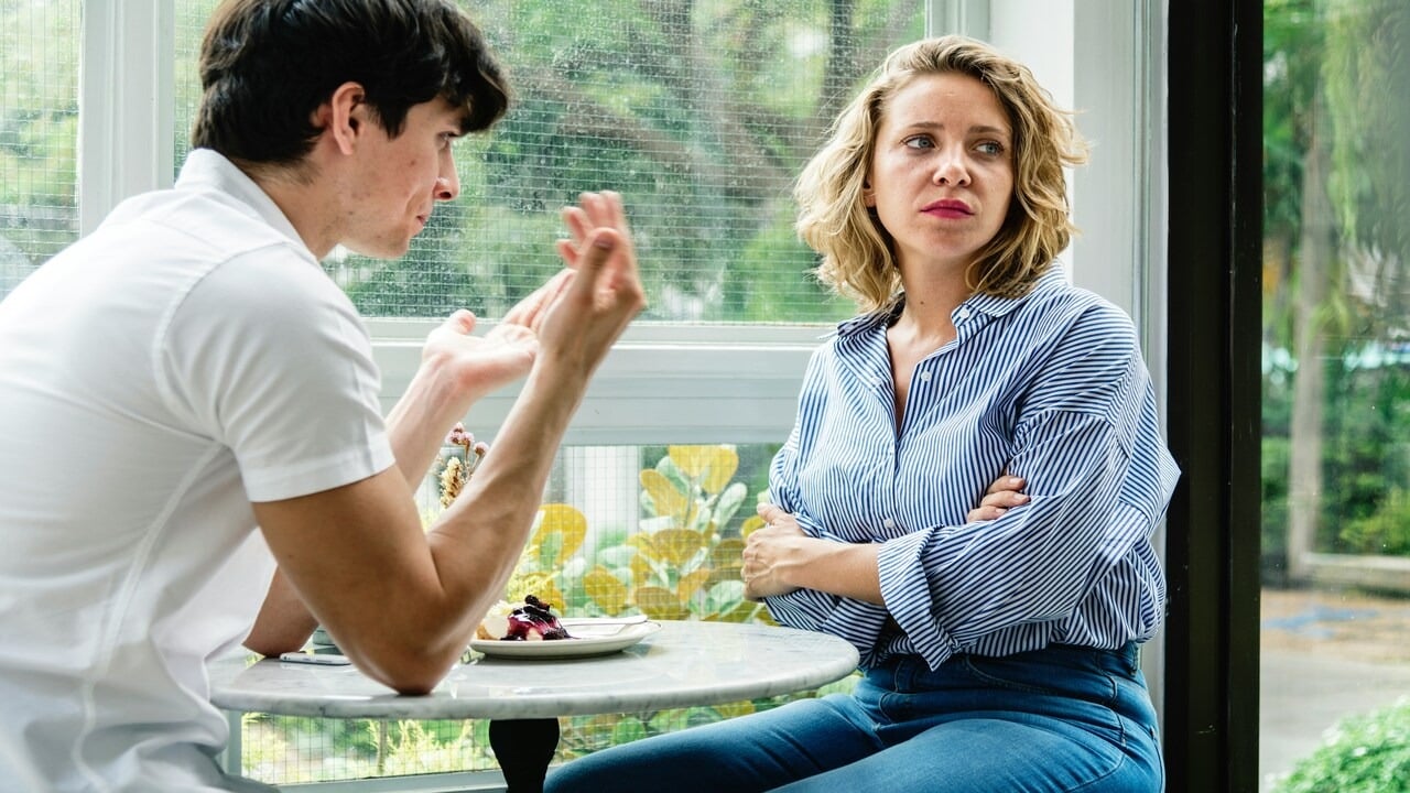 A couple arguing at a cafe