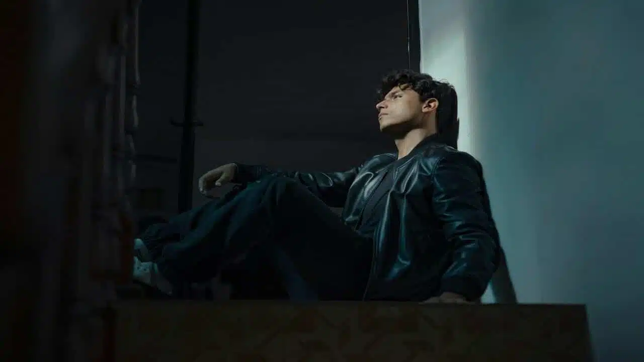 A man looking sad in a dark room