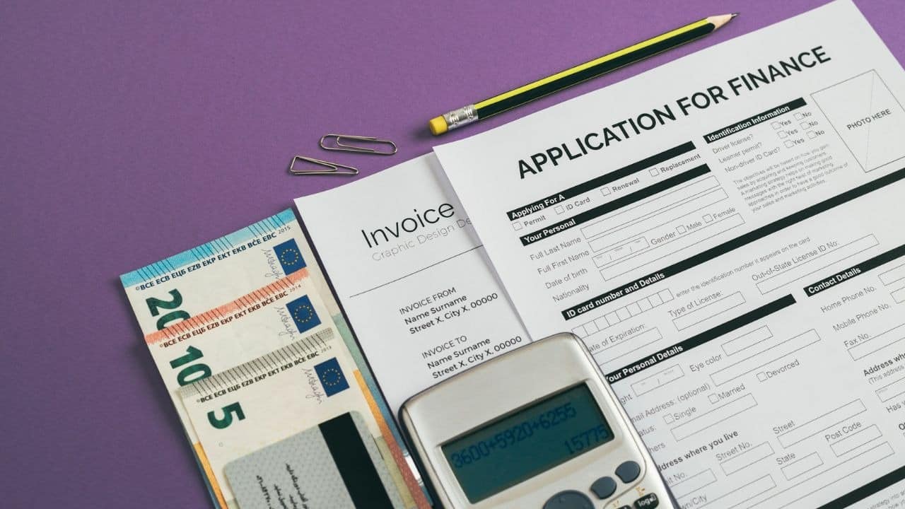 A finance application form, calculator, euro currency, and invoice are on a purple background