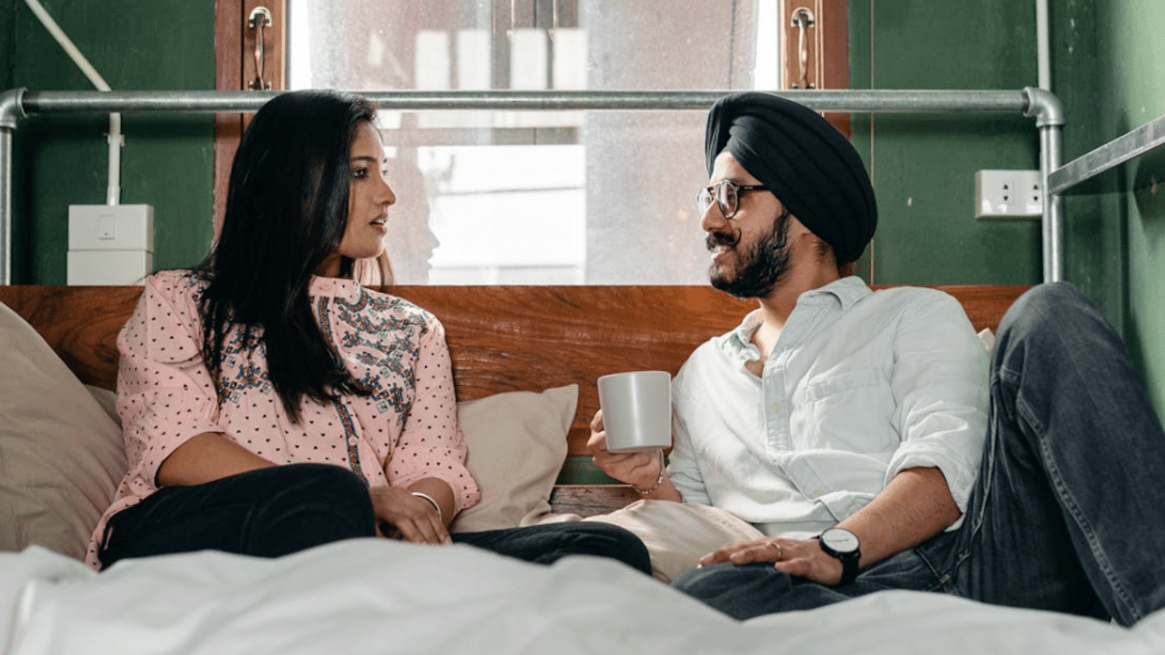A couple talking and resting in bed