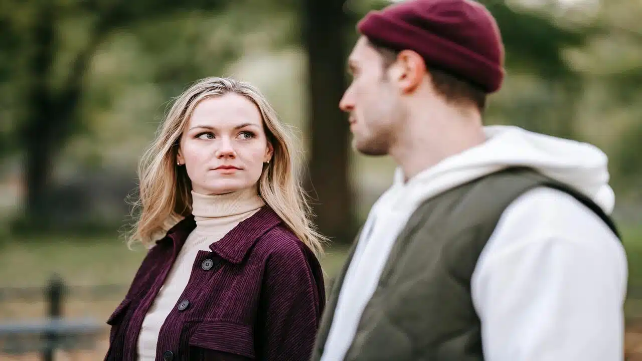 A couple looking at each other in the park