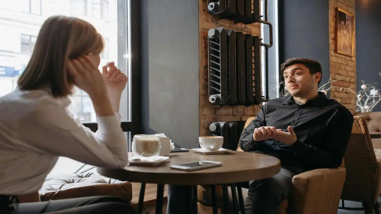 A couple talking at a coffee shop