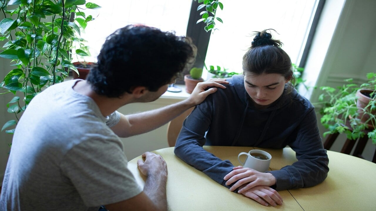 A couple looking sad while talking